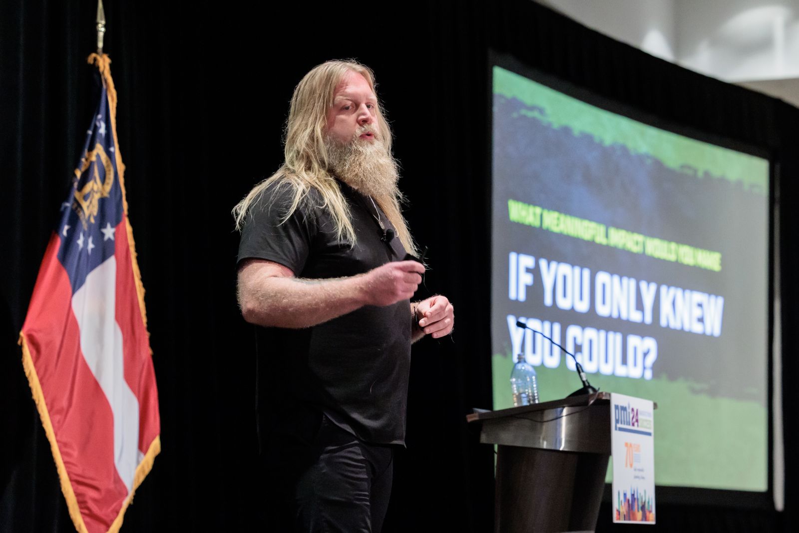 Justin Wren standing in front of a video screen